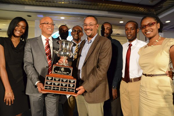 Rudolph Brown/Photographer
Christopher Barnes (right) Managing Director of the Jamaica Gleaner presents the Top Billing award to Oral McCook, (centre) CEO of OGM Integrated Communications and Everton Patterson, COO of OGM at the Gleaner advertisers appreciation and agency awards luncheion held at the Wyndham Hotel in New Kingston on Tuesday, February 19, 2013