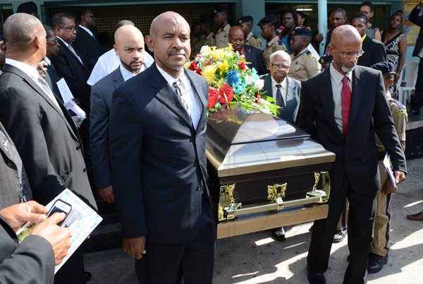 Rudolph Brown/Photographer
Pallbearers in front Frederick Boyd (left) and Dr Gene Archer, (right at back Jerome Archer, left) and Rev Claude Ellis (right) past Vice Principal at the Thanksgiving service for the life Rev Glen Archer at the Ardenne High School Auditorium in Kingston on Sunday, March 1, 2015