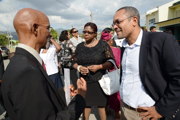 Rudolph Brown/Photographer
Christopher Barnes, managing director of the Gleaner greets Dr Gene Archer brother of Rev Glen Archer after the Thanksgiving service for the life Rev Glen Archer at the Ardenne High School Auditorium in Kingston on Sunday, March 1, 2015