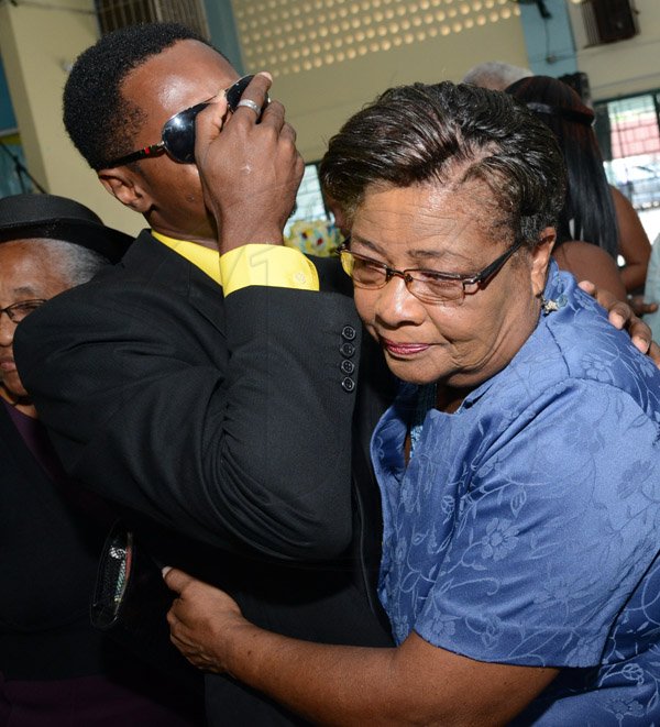 Rudolph Brown/Photographer
Rmell Newby, Speling Bee Champ  consoled by Past Vice Principal Carol Walfull at the Thanksgiving service for the life Rev Glen Archer at the Ardenne High School Auditorium in Kingston on Sunday, March 1, 2015
