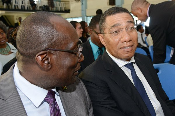 Rudolph Brown/Photographer
Andrew Holness, (right) Opposition Leader chat with Ruel Reid Principal of JC at the Thanksgiving service for the life Rev Glen Archer at the Ardenne High School Auditorium in Kingston on Sunday, March 1, 2015