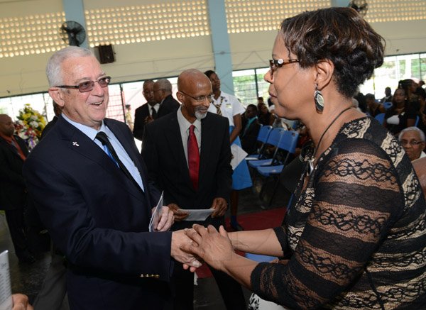 Rudolph Brown/Photographer
Ronald Thwaites left, Minister of Education greets Marcia Archer-Groves at the Thanksgiving service for the life Rev Glen Archer at the Ardenne High School Auditorium in Kingston on Sunday, March 1, 2015