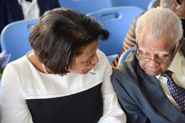 Rudolph Brown/Photographer
Nadine Molloy, Principal of Ardenne High chat with Rev Claude Ellis past vice principal Thanksgiving service for the life Rev Glen Archer at the Ardenne High School Auditorium in Kingston on Sunday, March 1, 2015
