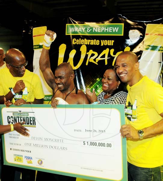 Contributed
 Devon “Concrete” Moncriffe (second left) raises his hand in triumph after defeating Tsetsi “Lights Out” Davis, in the final of the 2013 Wray & Nephew Contender boxing series. The event was held at the National Indoor Sports Centre on Wednesday.  Seen here with Moncriffe are Natalie Neita-Headley (second right), Minister without Portfolio in the Office of the Prime Minister with responsibility for Sports, Jimmy Lawrence (left) and Gary Dixon (right) of J. Wray & Nephew.  Moncriffe won the first place purse of $$1 million and the titles of Jamaica’s Ultimate Middleweight Boxer and the Wray & Nephew Contender. 