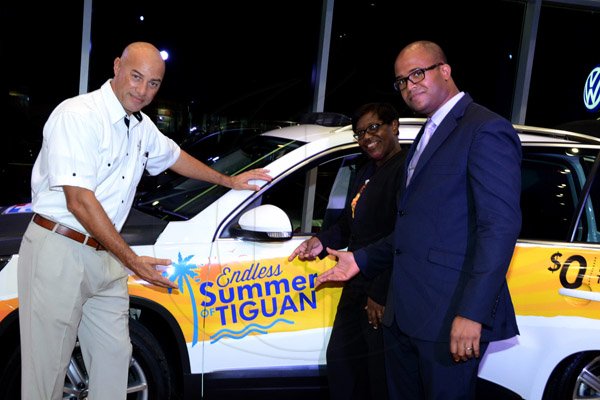Winston Sill/Freelance Photographer
BUSINESS DESK:-----ATL Automotive launch of the Endless Summer of Tiguan, VW SUV's, held at the VW Showroom, Oxford Road, New Kingston on Thursday night August 21, 2014. Here are Hugh Okoye (left), Assistant to Managing Director, ATL Automotive Limited;  Flora Humphrey (centre), Assistant Manager Personal Banking, Scotiabank; and Omar Spence (right), Manager, Marketing Programmes, Scotiabank.