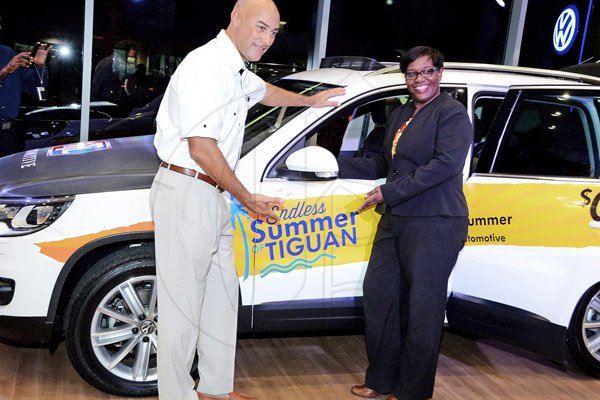 Winston Sill/Freelance Photographer
BUSINESS DESK:-----ATL Automotive launch of the Endless Summer of Tiguan, VW SUV's, held at the VW Showroom, Oxford Road, New Kingston on Thursday night August 21, 2014. Here are Hugh Okoye (left), Assistant to Managing Director, ATL Automotive Limited; and Flora Humphrey (right), Assistant Manager Personal Banking, Scotiabank.