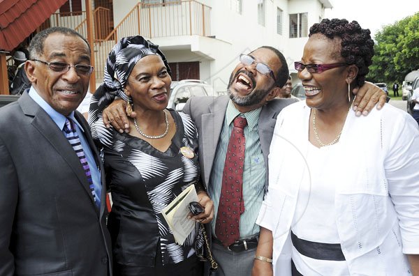 Norman Grindley/Chief Photographer
Formef deputy commissioner of police Owen Clunie, (left) and his wife Lorraine, (right) Hector 'Bingie' White, retired Senior superintendent of police (second right) and Inspector Monica Malcolm, in a jovial mood at the  Thanksgiving service for the life of Anthony 'Tony' Hewitt, retired senior Superintendent of police, held at the Boulevard Baptist church St. Andrew October 6, 2012.