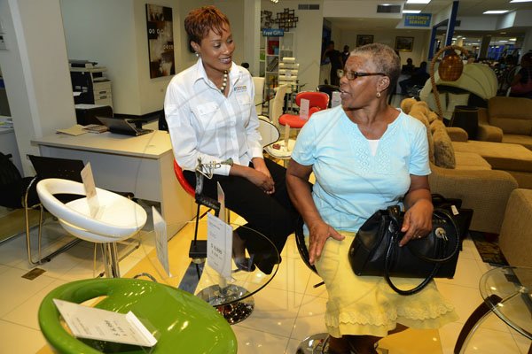 Rudolph Brown/Photographer
Janet Sylvester, (left) Director of Marketing chat with customer Millicent Clarke at the Courts (furniture Store) tour and press briefing at Courts , 29 Constant Spring Road on Wednesday, December 5, 2012