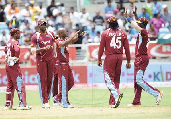 Ian Allen/Staff Photographer
West Indies stand-in captain Kieron Pollard (left) celebrates the taking of a wicket with Tino Best, Chris Gaye (second right) and Darren Sammy(right).



versus India in the Tri-Nation Cricket series at Sabina Park.
