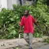 Norman Grindley/Chief Photographer
Resident remove falling tree from their home along Seaward Drive in  St. Andrew.