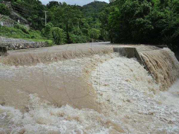 Ian Allen/Photographer
Sections of the Mona Resovoir catchment overflowing its embankment along the Gordon Town road in St.Andrew.