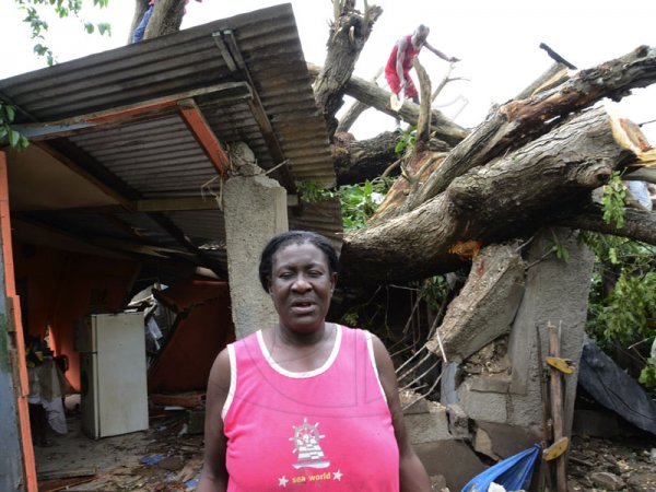 Rudolph Brown/Photographer
Angela Forbes tells how she made it out before this tree came crashing down on her house in Clifton in St Catherine.

Hurricane Sandy passes through Jamaica on damage properties on Thursday, October 25, 2012