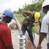 Anthony Minott/Freelance Photographer
Workmen from the Jamaica Public Service repair a utility pole that was damaged during the passage of Hurricane Sandy in Portmore, St Catherine last Thursday.