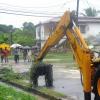 Norman Grindley/Chief Photographer
Workmen clear a block drain in New heaven St. Andrew.