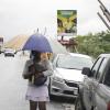Anthony Minott/Freelance Photographer
A woman shelters from the rain in Braeton after the passage of Hurricane Sandy in Portmore, St Catherine last Thursday.