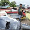 Ricardo Makyn/Staff Photographer
Fisherman Sheldon Clarke stands among Boats that have been brought ashore in Port Royal before Tropical Storm Sandy hits the island.