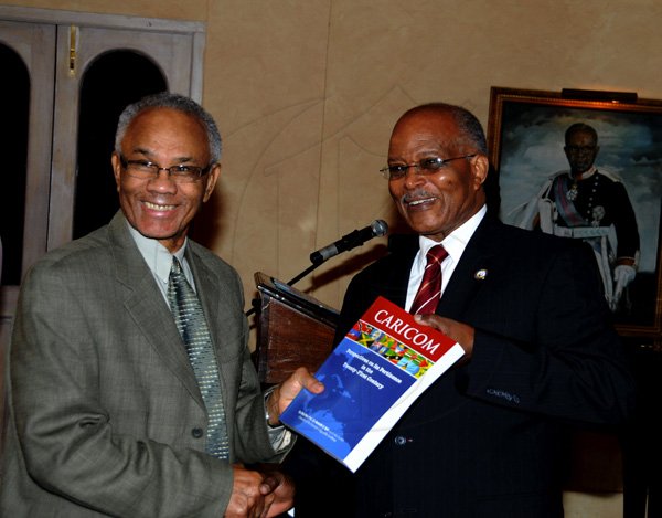 Winston Sill / Freelance Photographer
The University College of the Caribbean (UCC) function  to launch the UCC Foundation and launch of Sir Kenneth Hall's Book, held at King's House on Tuesday April 17, 2012. Here are Hon. Carlton Davis (left), Chairman, CHASE Fund; and Sir Kenneth Hall (right).