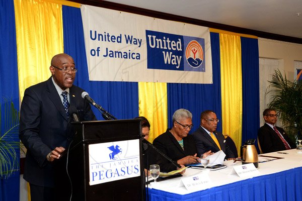 Winston Sill/Freelance Photographer
United Way of Jamaica annual Nation Builders'  Awards and  Employee Awards Ceremony, Held at the Jamaica Pegasus Hotel, New Kingston on Thursday September 11, 2014. Here are Ian Forbes (left), Chairman, United Way of Jamaica; Winsome Wilkins (second left), CEO, United Way of Jamaica; Mimister Anthony Hylton (centre); and Rev. Raymond Coke (right).
