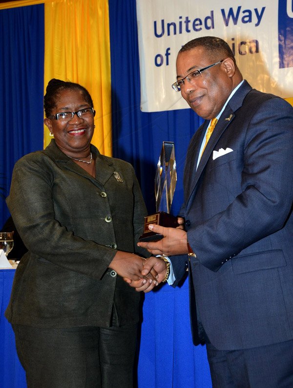 Winston Sill/Freelance Photographer
United Way of Jamaica annual Nation Builders'  Awards and  Employee Awards Ceremony, Held at the Jamaica Pegasus Hotel, New Kingston on Thursday September 11, 2014. Here are Ealane Livingston Smith (left), of JAMALCO; and Minister Anthony Hylton (right).