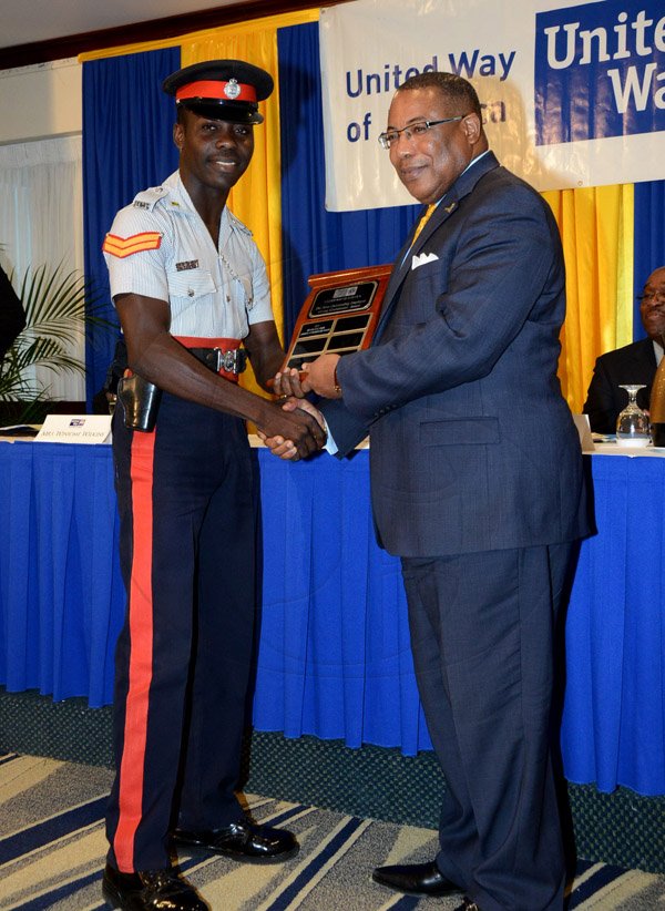 Winston Sill/Freelance Photographer
United Way of Jamaica annual Nation Builders'  Awards and  Employee Awards Ceremony, Held at the Jamaica Pegasus Hotel, New Kingston on Thursday September 11, 2014. Here are Corporal Andre Blair (left); and Minister Anthony Hylton (right).