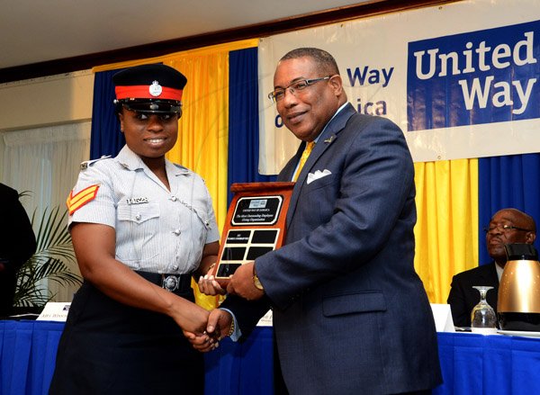 Winston Sill/Freelance Photographer
United Way of Jamaica annual Nation Builders'  Awards and  Employee Awards Ceremony, Held at the Jamaica Pegasus Hotel, New Kingston on Thursday September 11, 2014. Here are Woman Corporal Shermoine Hassock (left); and Minister Anthony Hylton (right).