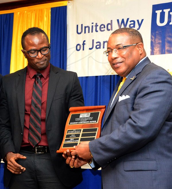 Winston Sill/Freelance Photographer
United Way of Jamaica annual Nation Builders'  Awards and  Employee Awards Ceremony, Held at the Jamaica Pegasus Hotel, New Kingston on Thursday September 11, 2014. Here are Marcus Steele (left), Managing Director, Carreras Limited accepting the Award for the Highest Corporate Donor, from Minister Anthony Hylton (right).