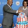 Winston Sill/Freelance Photographer
United States Ambassador Pamela Bridgewater joins hands with Security Minister Peter Bunting in cutting the red, white and blue Independence day cake  in honour of the 4th of July celebrations last Thursday.