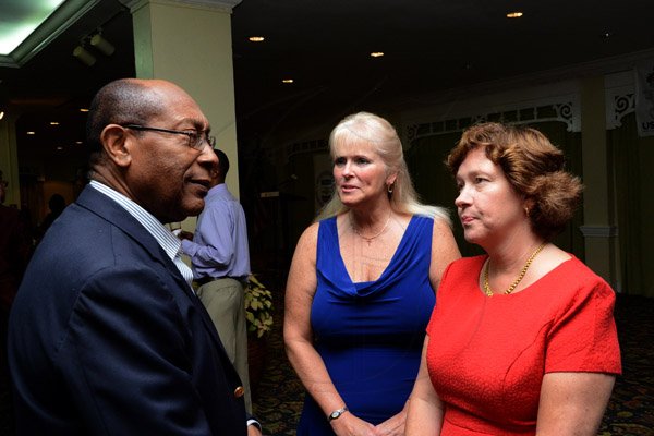 Winston Sill/Freelance Photographer
USAID/Jamaica host Appreciation Reception for their various partners and the private sector, for over 52 years, held at the Knutsford Court Hotel, Ruthven Road on Tuesday night December 9, 2014. Here are Dr. Henry Lowe (left);  Denise Herbol (centre), Mission Director, USAID; and Elizabeth Martinez (right), Charge d' Affaires, US Embassy.
