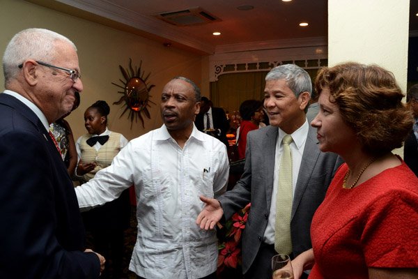 Winston Sill/Freelance Photographer
USAID/Jamaica host Appreciation Reception for their various partners and the private sector, for over 52 years, held at the Knutsford Court Hotel, Ruthven Road on Tuesday night December 9, 2014. Here are Minister of Education Ronald Thwaites (left); Milton Samuda (second left); Kevin Hendrickson (second right); and Elizabeth Martinez (right), Charge d' Affaires, US Embassy.