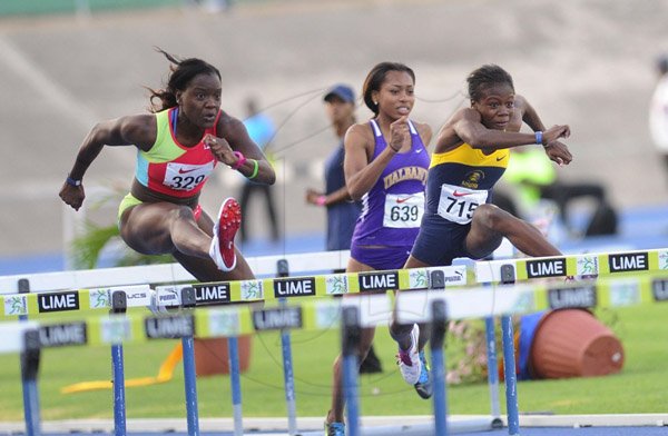 Ricardo Makyn/Staff Photographer 
Left Andrea Bliss of the MBA Track Club and Megan Simmonds of the University of the West Indies in the Women's 100 Meter Hurdles   at the Utech Classic's held at the National stadium on Saturday 13.4.2013