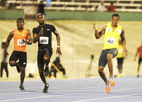 Ricardo Makyn/Staff Photographer 
 From left Dwight White of GC Foster College,Kim Collins race ahead as Yohan Blake pulls up while feeling cramps in the Men's  100 Meter    at the Utech Classic's held at the National stadium on Saturday 13.4.2013