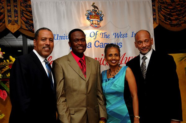 Winston Sill / Freelance Photographer
The University of the West Indies (UWI) Mona, Jamaica Long Service AwardsDinner,held at the Mona Visitors Lodge on Thursday night December 13, 2012. Here are Prof. Gordon Shirley (left); Anthony Sheriffe (second left), 40 year long serviceawardee; Dr. Camile Bell-Hutchinson (second right); and Douglas Orane (right).