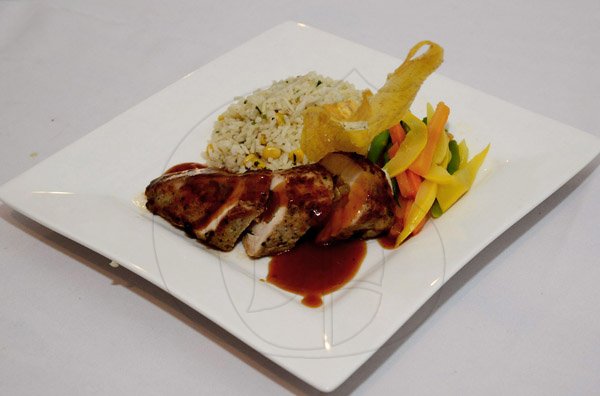 Winston Sill/Freelance Photographer
Brian Lumley's lovely apple and cheese stuffed jerk chicken breast served with sweet corn and parsley Jasmine rice accompanied by sautéed market vegetables.