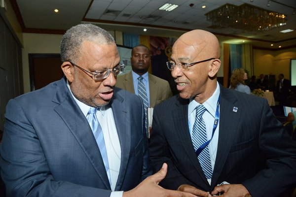 Rudolph Brown/Photographer
Business Desk
Dr Peter Phillips, (left) Minister of Finance Planning and Public Service chat with Milverton Reynolds, Managing Director of the Development Bank of Jamaica at the Venture Capital One Day Conference at Jamaica Pegasus Hotel in New Kingston on Monday, September 9,2013
