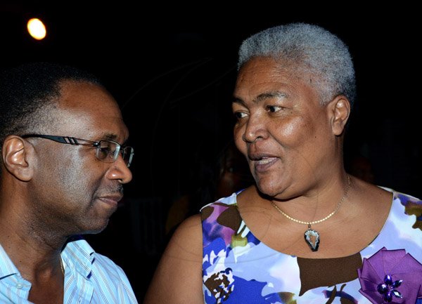 Winston Sill/Freelance Photographer
PUBLIC AFFAIRS DESK:----- Financial advisor Wayne Wray listens keenly to president and CEO of United Way of Jamaica Winsome Wilkins at the Victoria Mutual Building Society Anniversary Reception, held at The East Lawn, Devon House, Hope Road on Friday night November 14, 2014.