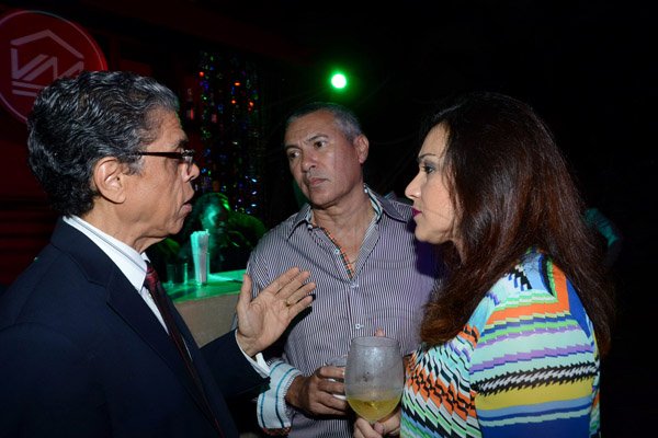 Winston Sill/Freelance Photographer
PUBLIC AFFAIRS DESK:----- President and CEO of Victoria Mutual Building Society Richard Powell (left) chats with Steven Marston and wife Gia Abraham at the company's Anniversary Reception, held at The East Lawn, Devon House, Hope Road on Friday night November 14, 2014.