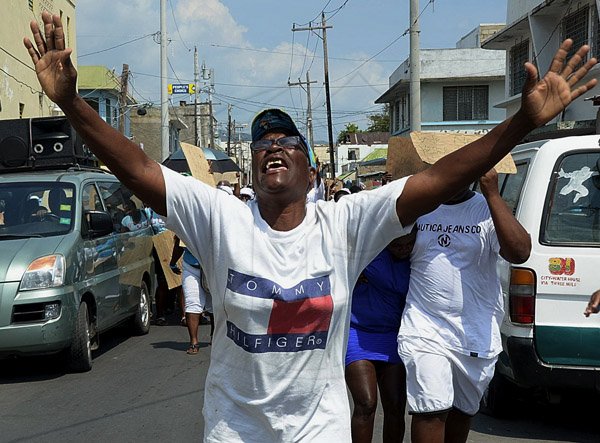 Ian Allen/Photographer
This woman gets into the spirit during the prayer walk through West Kingston on Wednesday.