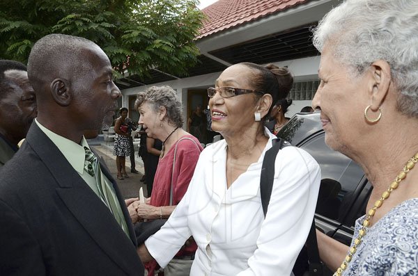 Gladstone Taylor / Photographer

Donald Cammoc (left) and Norma Ettrick greet and give emotional support to wife of the late Wilmot 'Motty' Perkins, Elaine (center), at a thanksgiving service for the life of the veteran talk show host. The service was held at  the Webster Memorial United Church, Kingston yesterday . Mr Perkins died from complications with pneumonia earlier this month.