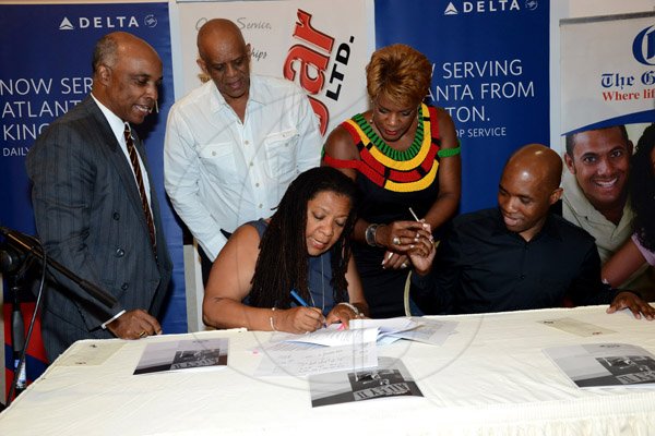 Winston Sill/Freelance Photographer
PUBLIC AFFAIRS DESK:-----Pauline Findlay (seated, left) trustee and chair of the Wolmer's Board of Management and Troy Powell (seated, right) artistic director of Ailey II dance company, sign the agreement to bring Ailey II to Jamaica. Witnessing the signing are (standing, from left) Christopher Samuda, Conrad Graham and Michelle Wilson-Reynolds. Wolmers Trust presents the Media Launch of Ailey2, held at the Jamaica Pegasus Hotel, New Kingston on Thursday night may 29, 2014.
