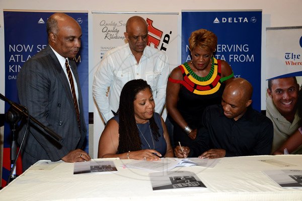 Winston Sill/Freelance Photographer
PUBLIC AFFAIRS DESK:-----Troy Powell (seated, right) artistic director of Ailey II dance company, and Pauline Findlay (seated, left) trustee and chair of the Wolmer's Board of Management, sign the agreement to bring Ailey II to Jamaica. Witnessing the signing are (standing, from left) Christopher Samuda, Conrad Graham and Michelle Wilson-Reynolds. 
Trust presents the Media Launch of Ailey2, held at the Jamaica Pegasus Hotel, New Kingston on Thursday night may 29, 2014.