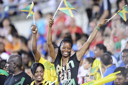 Ricardo Makyn/Staff Photographer 
Jamaicans waves their flags in the stands during the 2011 IAAF World Championships in Athletics at  Daegu Stadium in South Korea yesterday.