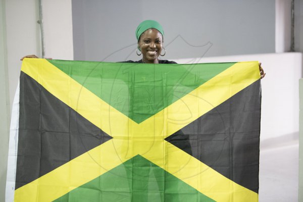 Natalie Edwards poses with a Jamaican flag in support of the National Track and field team at the Khalifa International Stadium.2019 IAAF World Athletic Championships at the Khalifa International Stadium in Doha, Qatar on Friday September 27, 2019