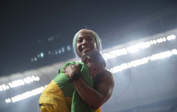 100m Women world champion Shelly-Ann Fraser Pryce celebrates win with son Zion at the  2019 IAAF World Athletic Championships held at the Khalifa International Stadium in Doha, Qatar on Sunday September 29, 2019.