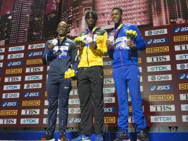 Tajay Gayle (center) wins, Jamaica’s first world champion in the long jump event on the medal podium at the  2019 IAAF World Athletic Championships held at the Khalifa International Stadium in Doha, Qatar on Sunday September 29, 2019.