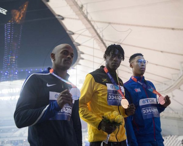 Tajay Gayle (center), Jamaica’s first world champion in the long jump event, on the medal podium at the  2019 IAAF World Athletic Championships held at the Khalifa International Stadium in Doha, Qatar on Sunday September 29, 2019.