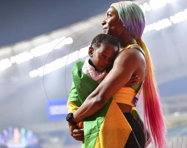 Newly crowned world champion Shelly-Ann Fraser-Pryce celebrates her win with son Zyon Pryce at the 2019 IAAF World Athletic Championships held at the Khalifa International Stadium in Doha, Qatar on Sunday September 29, 2019.