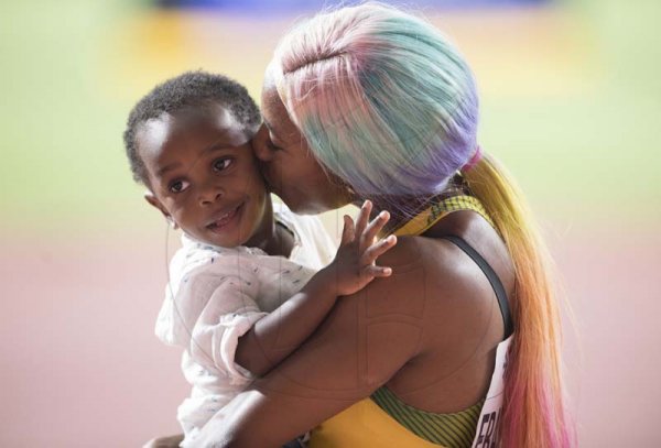 100m Women world champion Shelly-Ann Fraser Pryce celebrates win with son Zyon at the  2019 IAAF World Athletic Championships held at the Khalifa International Stadium in Doha, Qatar on Sunday September 29, 2019.