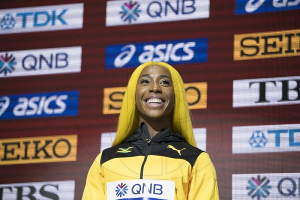 100m world champion Shelly-Ann Fraser-Pryce takes her place at the top of the medal platform to accept her gold medal for the 100m women event at the
