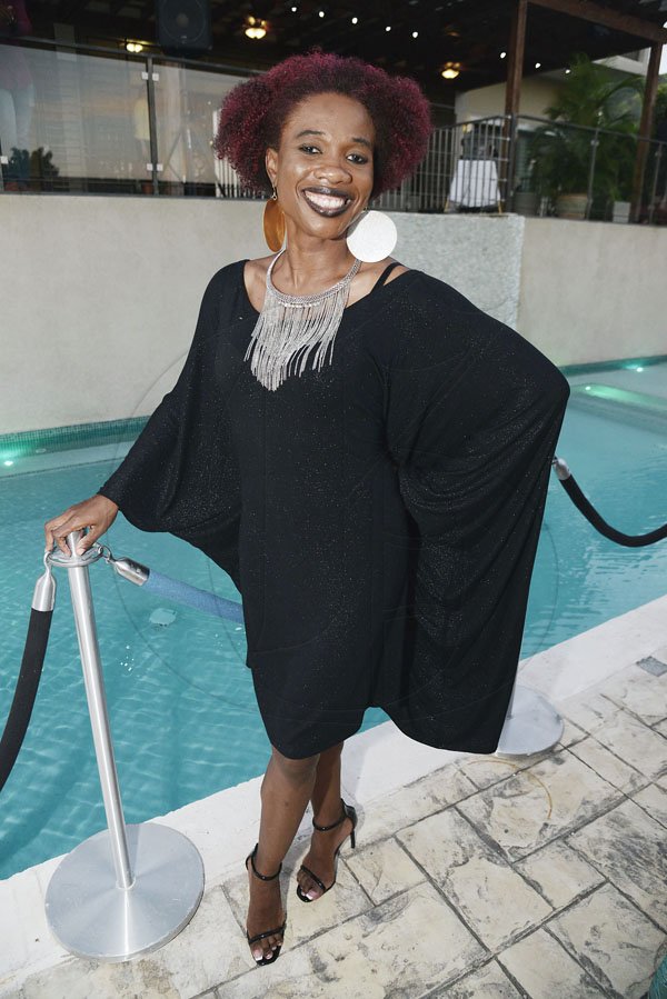 Rudolph Brown/PhotographerAndrea Wilson is caught by the poolside in this stylish black ensemble.