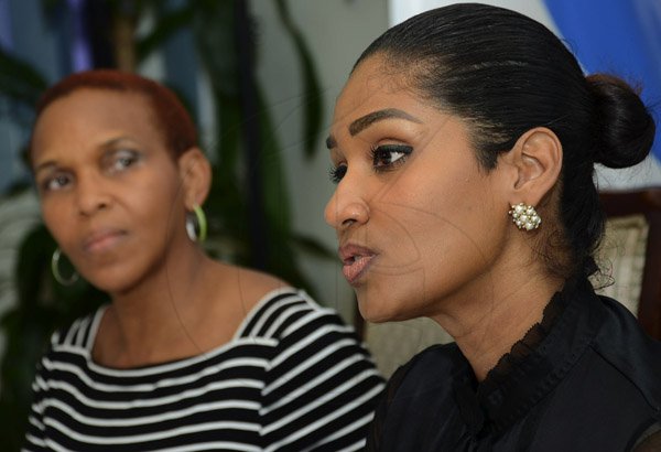 Rudolph Brown/Photographer
Maureen Webber, (left) Programme Manager of (Y.U.T.E.)  and Lisa Hanna, Minister of Youth and Culture speaks at NYS Summer Programme Press Launch at 6 Collins Green Avenue in Kingston on Wednesday, April 3, 2013